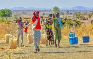 Daily rotine for young girls bringing water from wells to avoid paying the cost of buying water